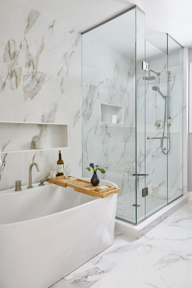 Freestanding tub and polished tile in luxury bathroom in Toronto