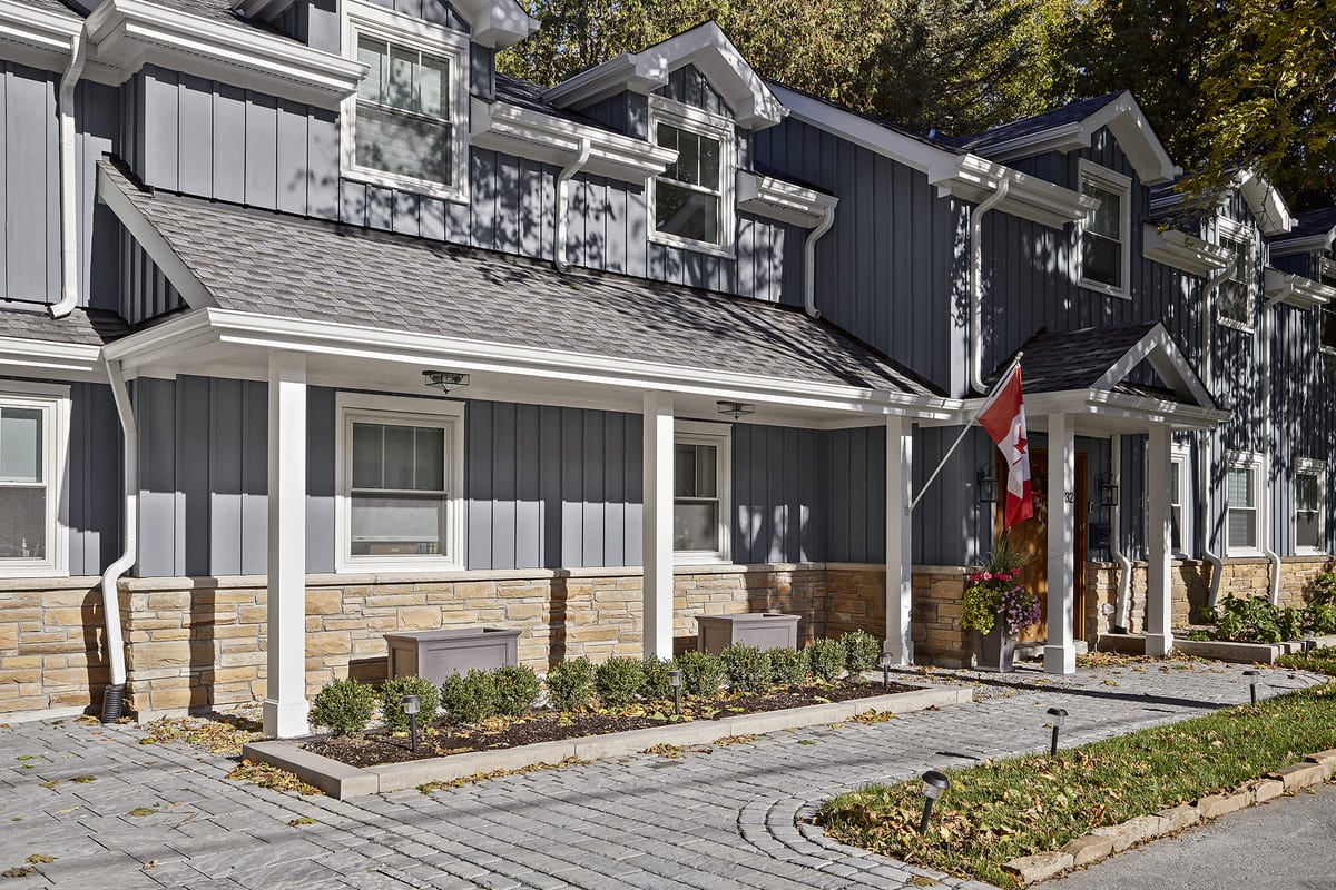 Front view of cottage renovation with white porch posts 