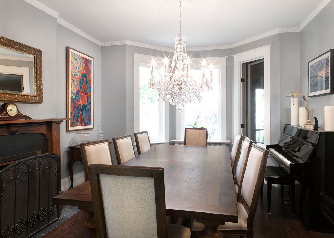 Transitional dining room with chandelier above table