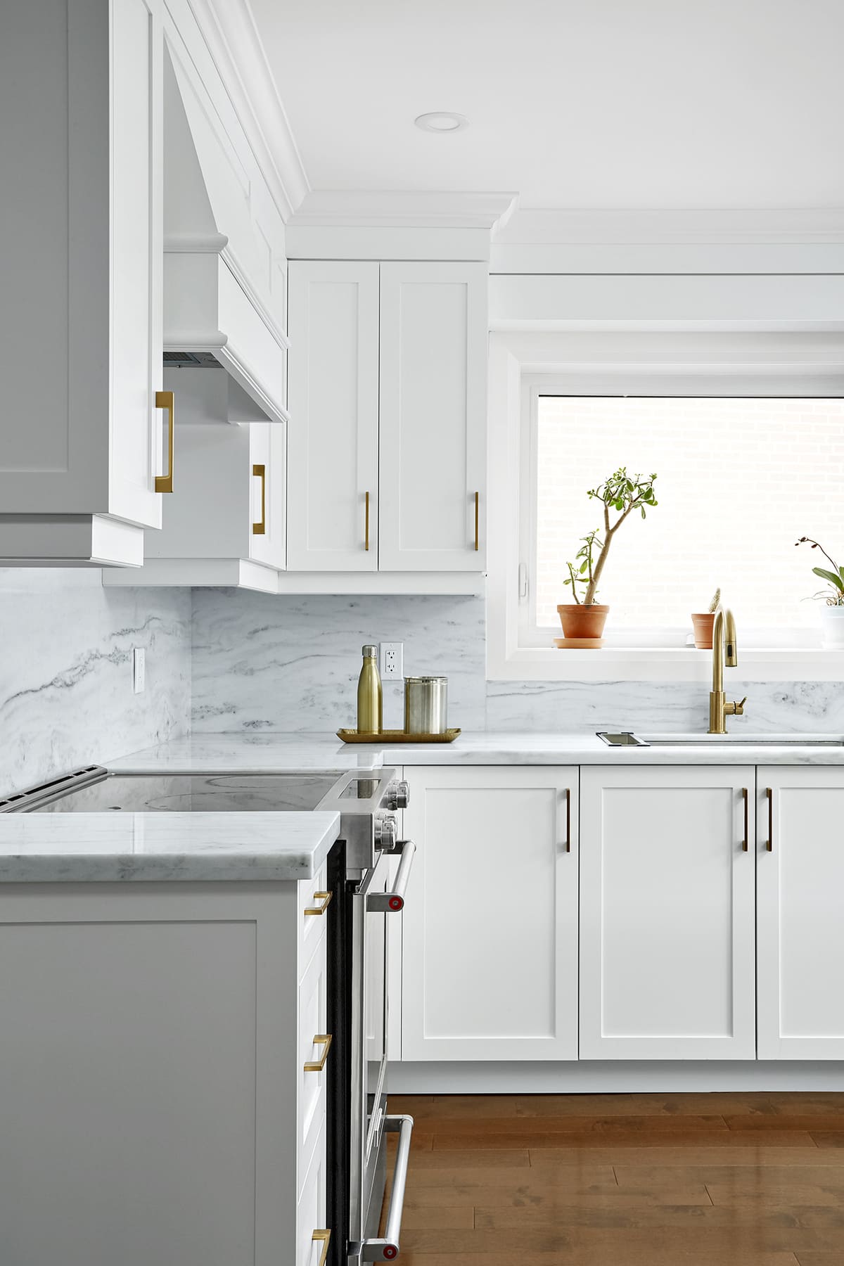 White shaker cabinets and window behind sink in Markham kitchen renovation by Master Edge Homes