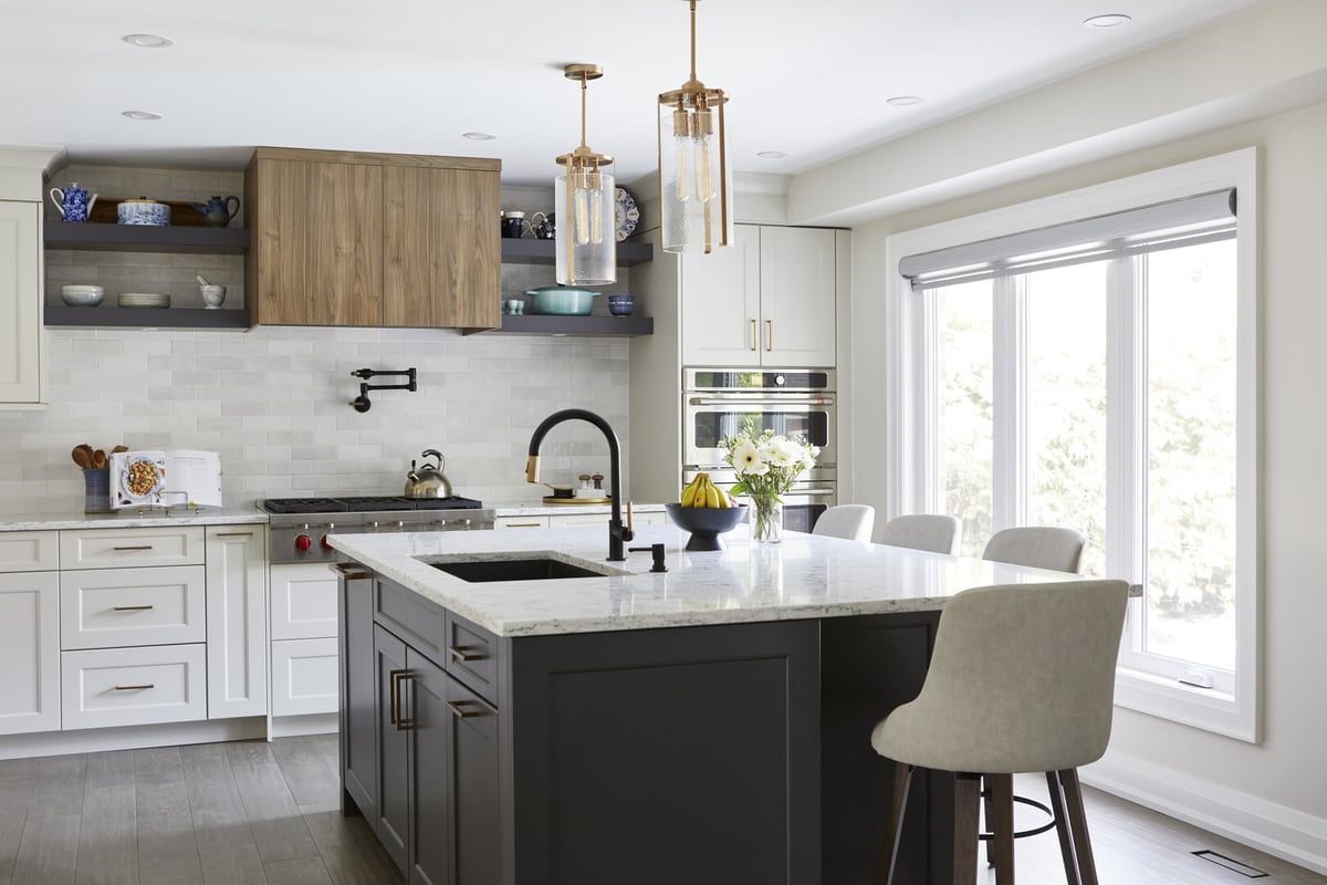 Kitchen island with sink and seating in renovation by Master Edge Homes