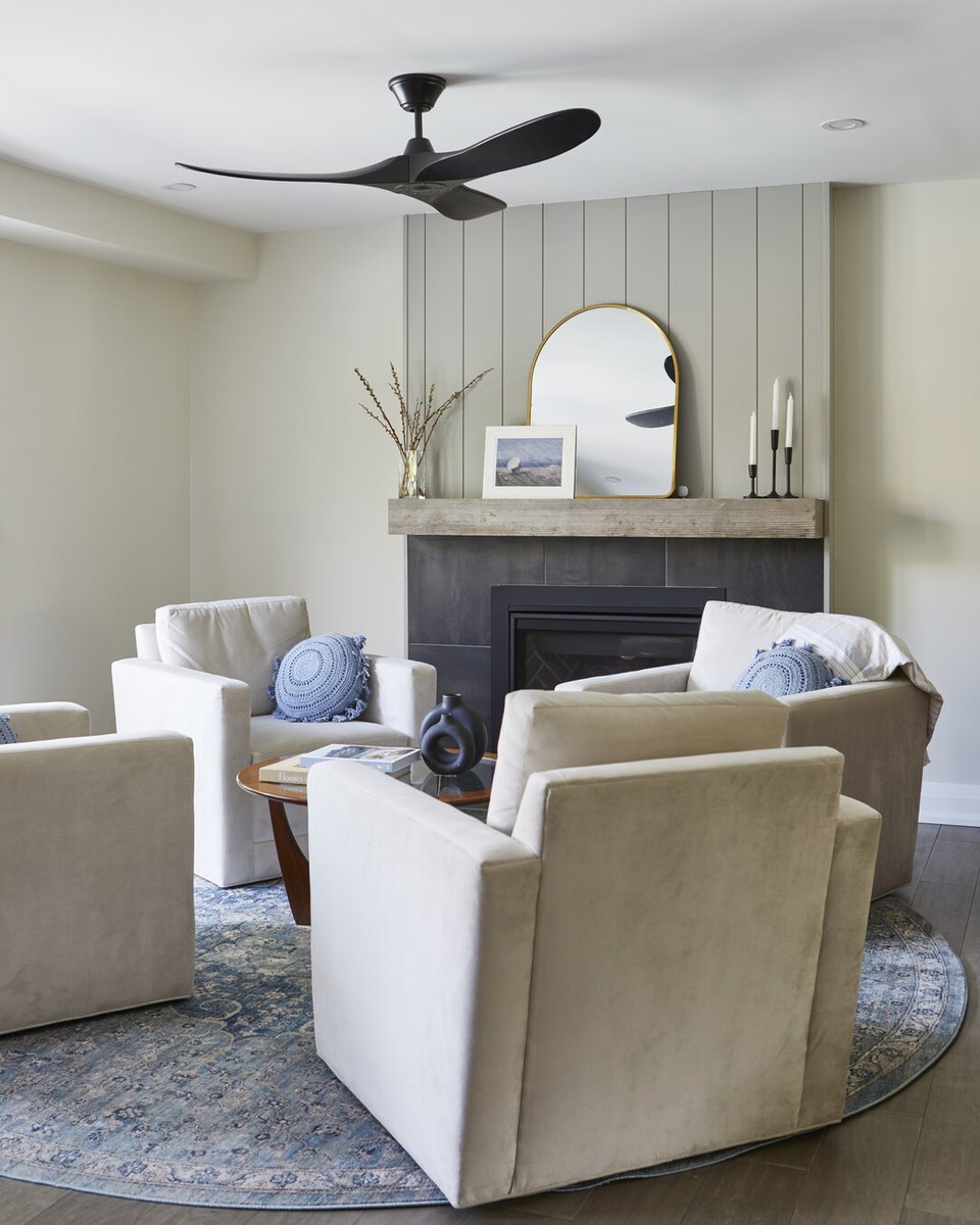 Main floor home renovation in Markham, Ontario with modern fireplace and ceiling fan above chairs