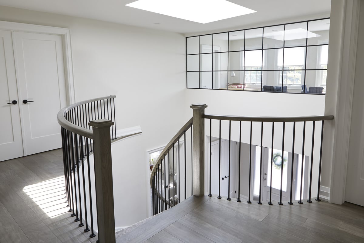 Second-story of Markham home renovation with curved staircase and square trim windows in back