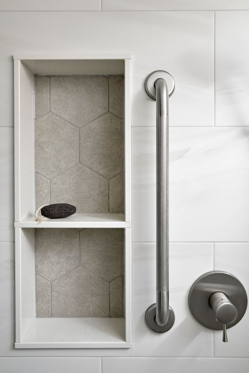 Shower nook with hexagonal tile and aging in place handle feature in bathroom renovation in Markham, Ontario