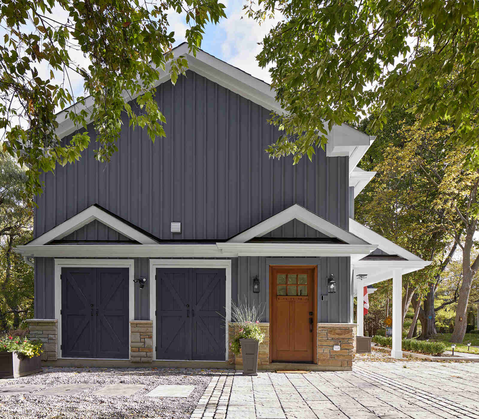 Side exterior view of home renovation with two barn doors in Markham
