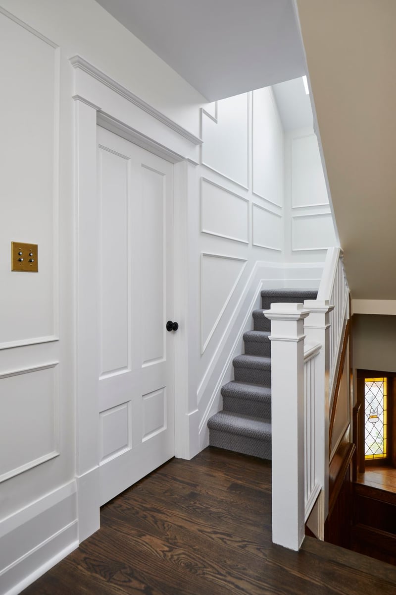 White walkway to stairs and wainscotted walls in Markham home renovation
