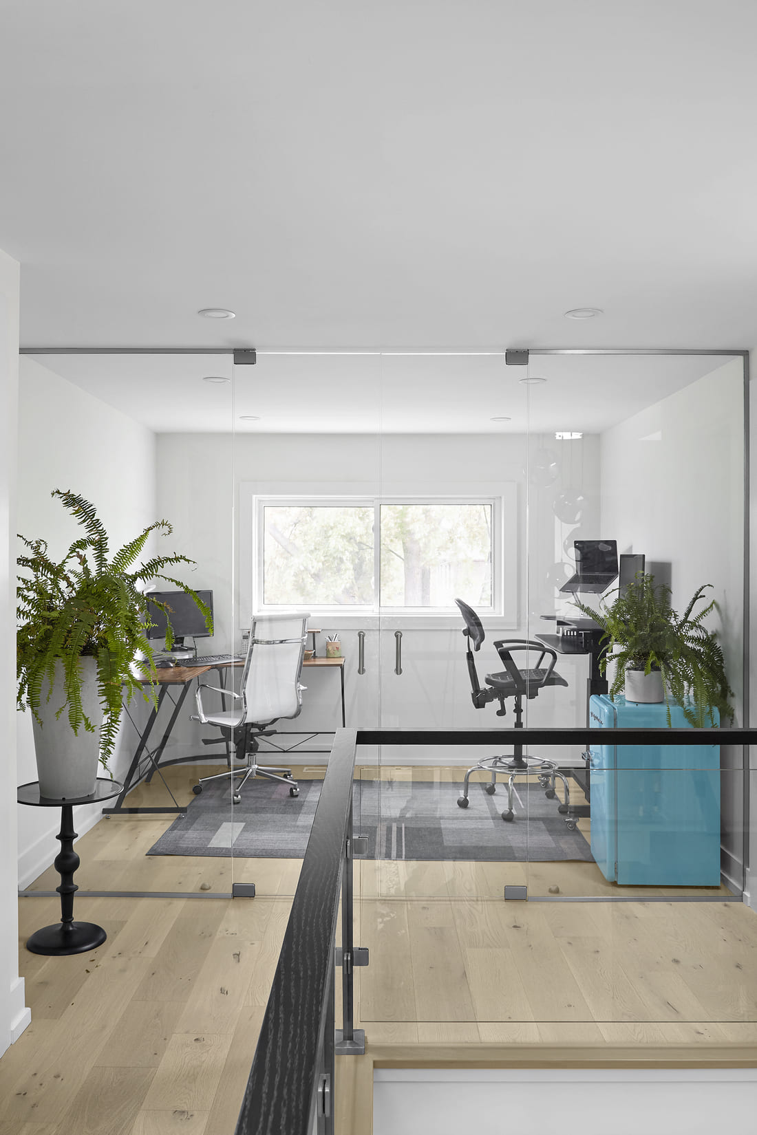 custom home office behind glass partition