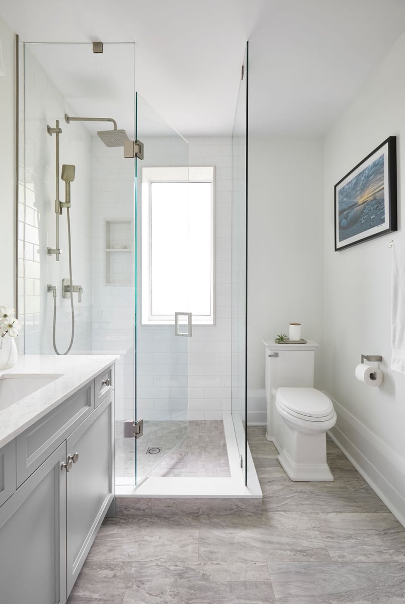 modern white bathroom renovation in Markham with glass pane shower