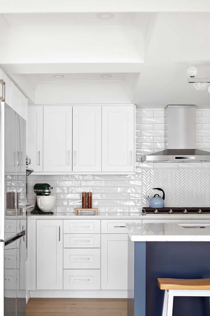 Modern white kitchen cabinets with white tile backsplash in Markham kitchen renovation